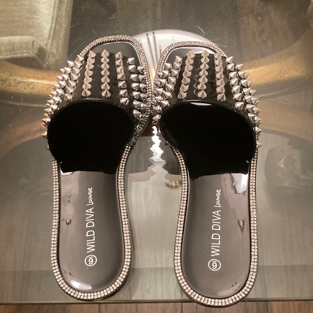 Black, flat, plastic  sandals with spike studs, and rhinestones
